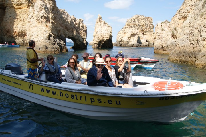 a group of people riding on the back of a boat